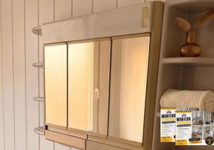 a cabinet with glass doors on a wall at Herz Monteur City-Apartment Halberstadt Dom in Halberstadt +1 photo