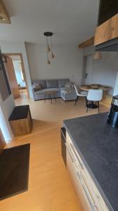 a living room with a couch and a table at Pfälzerblick Lambrecht- Ferienwohnung mit Garten in Lambrecht