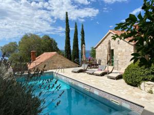 a swimming pool in front of a house at Villa Zeleni raj in Omiš