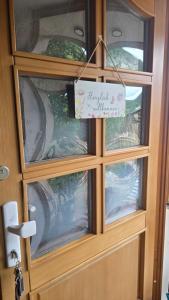 a door with a sign that reads happy field milk at Pfälzerblick Lambrecht- Ferienwohnung mit Garten in Lambrecht +17 photos