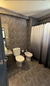 a bathroom with a toilet and a sink at Aires Express in Buenos Aires +25 photos
