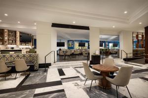a lobby with a restaurant with tables and chairs at Hilton Boston Back Bay in Boston