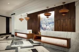 a lobby with two benches and a painting on the wall at Hilton Boston Back Bay in Boston