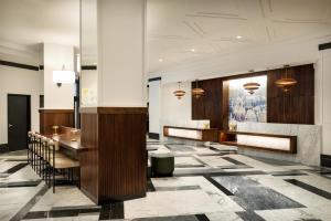 a lobby with a table and chairs in a building at Hilton Boston Back Bay in Boston +87 photos