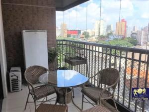 a table and chairs on a balcony with a view at Apt 2019 in Paulínia