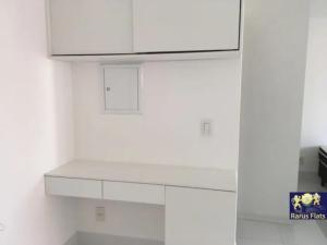 a kitchen with white cabinets and a white counter top at Apt 2019 in Paulínia