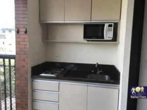 a kitchen with a sink and a microwave at Apt 2019 in Paulínia