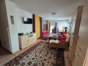 a living room with a couch and chairs and a tv at Appartement Simone Hofherr in Imst