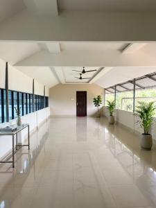 an empty hallway with plants in a building at Hotel Grand Illam in Ernakulam