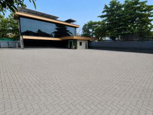 a building with a brick driveway in front of a building at Hotel Grand Illam in Ernakulam