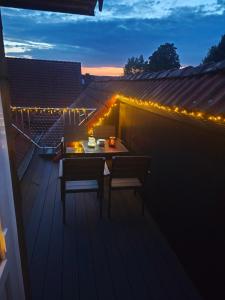 a table and chairs on a deck with lights at Ferienwohnung Freise in Telgte