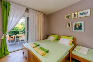 a bedroom with two beds and a balcony at Wild Beauty in Sutomore