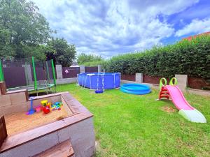 a backyard with a play area with a sandbox and a frisbee at Glamping 68 - Summer cottage in Kámen