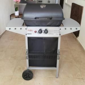 a grill sitting on a white table with a grill at Glamping 68 - Summer cottage in Kámen +16 photos
