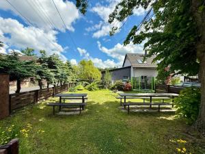 two picnic tables in the grass in a yard at Glamping 68 - Summer cottage in Kámen