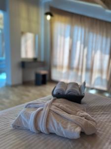 a towel sitting on top of a bed at RestList in Haghpat