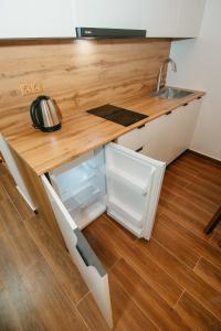 a kitchen with a sink and a wooden counter top at Villa Mirakula Kvariati in Kvariati