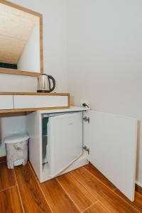 a kitchen with white cabinets and a refrigerator at Villa Mirakula Kvariati in Kvariati +58 photos