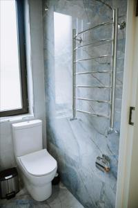 a bathroom with a toilet and a walk in shower at Quba Garden Resort in Quba +49 photos