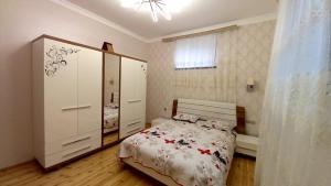 a bedroom with a bed and a dresser at Village in Oğuz