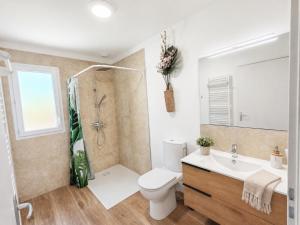 a bathroom with a toilet and a sink and a shower at Le temps de la pause 1 in Cepoy