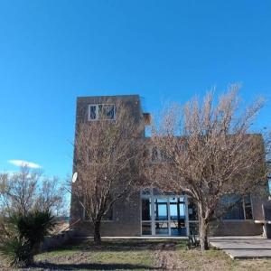a building with two trees in front of it at Aquamarinas Departamentos in Playas Doradas +3 photos