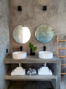 two sinks in a bathroom with two mirrors at Design Luxury Villa in Holbox Island +44 photos