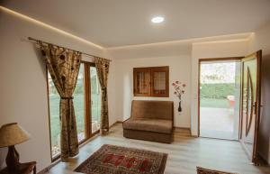 a living room with a couch and sliding glass doors at Holiday home Emma in Ripač