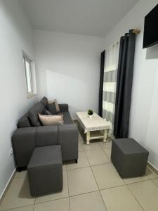 a living room with a couch and a table at Hotel Luis in Durrës