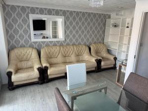 a living room with a couch and a table at Ramskir Apartment in Doncaster