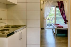 a kitchen with a bed and a bedroom with a window at Wild Beauty in Sutomore +63 photos