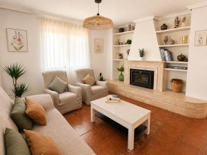 a living room with a couch and a fireplace at El Refugio de Leyla in Masía de Correntilla