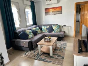 a living room with a couch and a coffee table at Casa Emperador Penthouse in Roldán