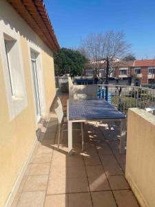 a blue table and chairs on a balcony at Spacious 3-room apartment in Fréjus