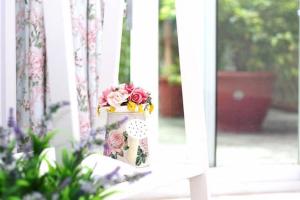 a vase filled with flowers sitting in a window at Qing Noise Villas in Hualien City