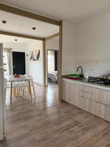 a kitchen with a table and a dining room at Complejo San Carlos in General Acha