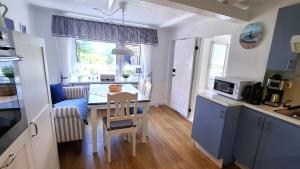a kitchen with a table and a dining room at Ferienwohnung Alte Schmiede in Wangerland