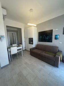 a living room with a couch and a table at Loft Pietrasanta in Pietrasanta