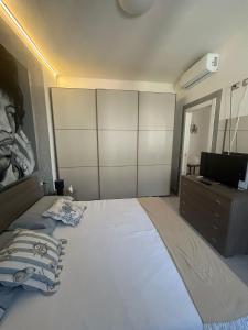 a bedroom with a large bed and a television at Loft Pietrasanta in Pietrasanta +13 photos