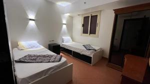 a room with two beds and a window at 2BR Sea View Chalet Porto sokhna in Ain Sokhna +72 photos