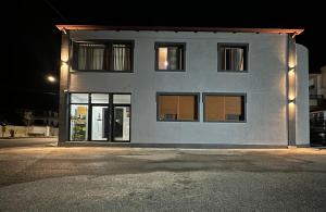 a building with windows at night at Aral Hostel in Berat