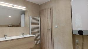 a bathroom with a sink and a mirror at Rekreačné domy pod Vlkolíncom in Ružomberok
