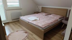 a bedroom with a bed with a wooden head board at Rekreačné domy pod Vlkolíncom in Ružomberok +22 photos