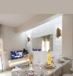 a living room with a table and a tv at Boutique lux apartments in Kavála