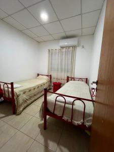 a room with two beds and a window at Jade in Chajarí