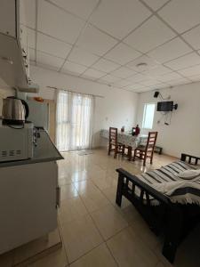 a kitchen and a living room with a table and chairs at Jade in Chajarí