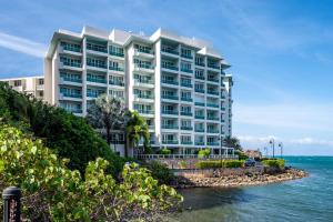 a large white building next to the ocean at Premier Ocean Lagoon Studio · Condado with Pool in San Juan