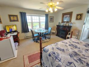 a bedroom with a bed and a table and chairs at Digby Bed and Breakfast in Digby