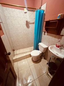 a bathroom with a toilet and a sink at Estancia 2 in Tena