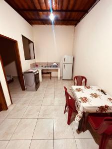 a kitchen with a table and a table and a refrigerator at Estancia 2 in Tena